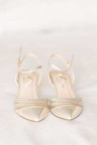 Delicate gold wedding shoes.