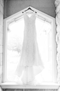Wedding dress hanging in church window.