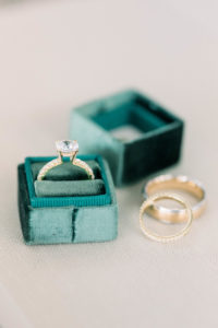 Gold wedding ring with green velvet box.